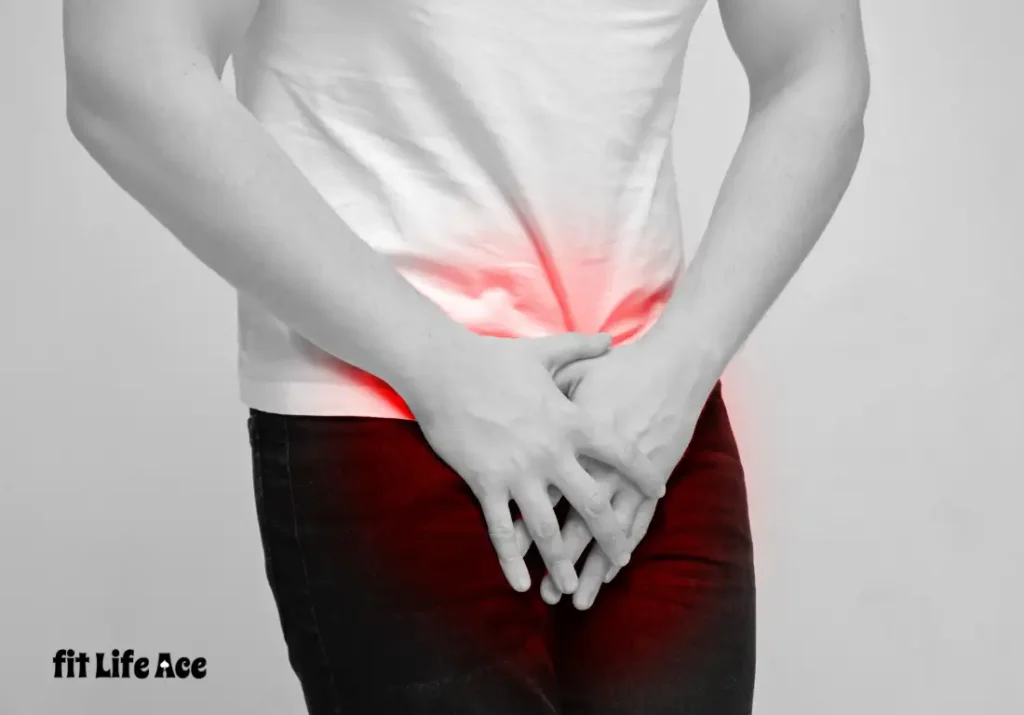 A man in a white shirt and dark pants holding his lower abdomen with both hands, showing signs of pelvic discomfort; red gradient highlights the pain area.